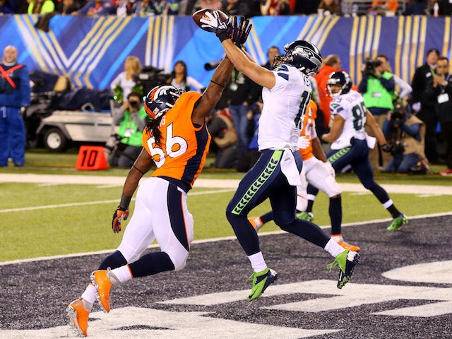 Wide receiver Jermaine Kearse #15 of the Seattle Seahawks tries to make a catch against outside linebacker Nate Irving #56 of the Denver Broncos on February 2, 2014