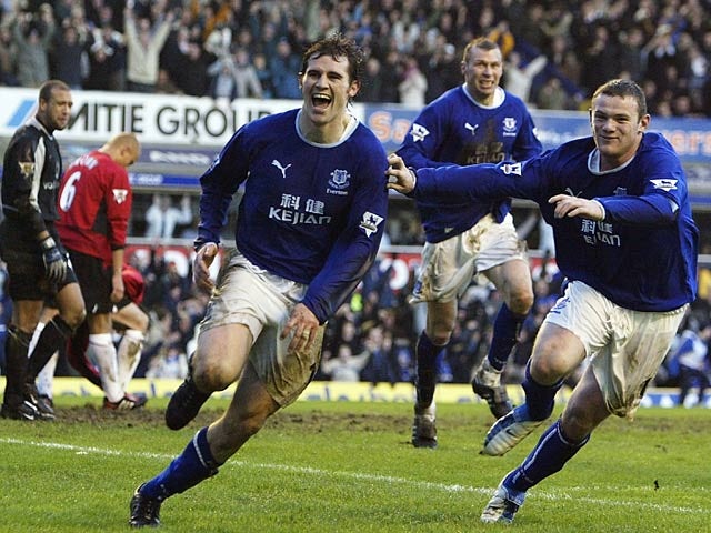 Kevin Kilbane celebrates with Wayne Rooney after scoring his team's third goal against Man United during their Premier League match on February 7, 2004