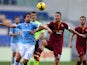 Alvaro Gonzalez of SS Lazio competes for the ball with Francesco Totti of AS Roma during the Serie A match between SS Lazio and AS Roma at Stadio Olimpico on February 9, 2014