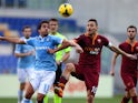 Alvaro Gonzalez of SS Lazio competes for the ball with Francesco Totti of AS Roma during the Serie A match between SS Lazio and AS Roma at Stadio Olimpico on February 9, 2014