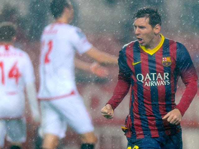 Barcelona's Lionel Messi celebrates after scoring his team's second goal against Sevilla during their La Liga match on February 9, 2014