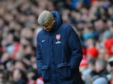 Arsenal Manager Arsene Wenger looks dejected during the Barclays Premier League match between Liverpool and Arsenal at Anfield on February 8, 2014