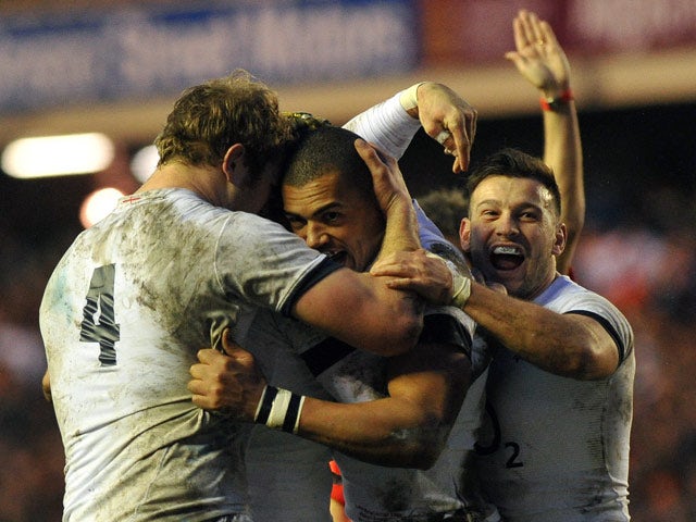 England's Luther Burrell is congratulated by teammates after scoring the opening try against Scotland during their Six Nations match on February 8, 2014