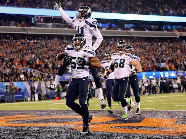 Outside linebacker Malcolm Smith #53 of the Seattle Seahawks celebrates his 69-yard touchdown with teammates after intercepting a pass against the Denver Broncos on February 2, 2014