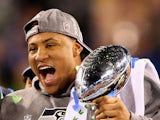 Outside linebacker and Super Bowl MVP Malcolm Smith #53 of the Seattle Seahawks holds the Vince Lombardi Trophy after winning Super Bowl XLVIII on February 2, 2014