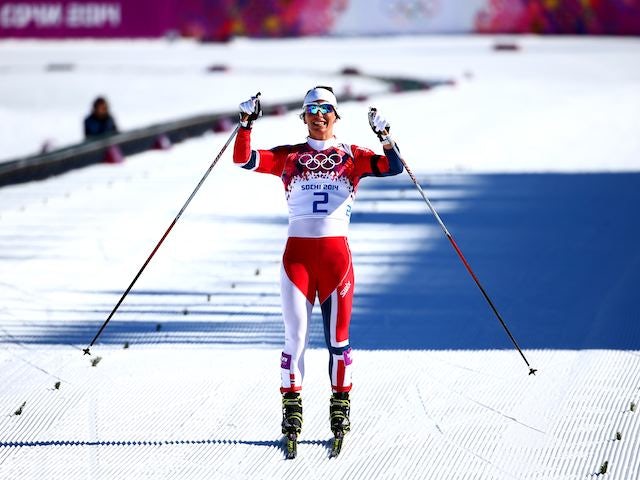 Norway's Marit Bjoergen celebrates winning gold in the women's skiathlon on February 8, 2014.