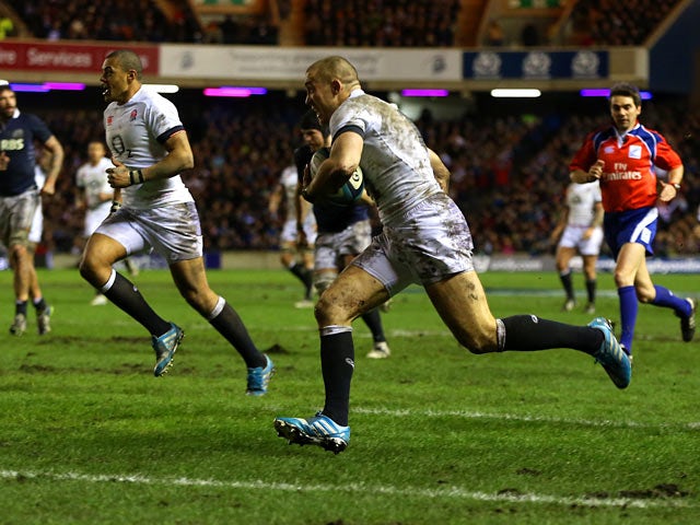 England's Mike Brown runs ahead to score a try against Scotland during their Six Nations match on February 8, 2014