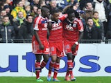 's French forward Alexandre Lacazette is congradulated by Lyon's French defender Samuel Umtiti and Lyon's French forward Bafetimbi Gomis during the French L1 football match between Nantes and Lyon on February 9, 2014