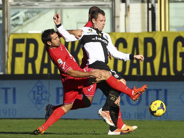 Antonio Cassano of Parma FC competes for the ball with Fabian Andres Rinaudo of Calcio Catania during the Serie A match between Parma FC and Calcio Catania at Stadio Ennio Tardini on February 9, 2014