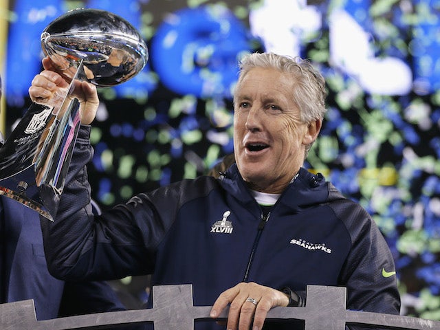 Head coach Pete Carroll of the Seattle Seahawks celebrates with the Vince Lombardi Trophy after their 43-8 victory over the Denver Broncos during Super Bowl XLVIII on February 2, 2014