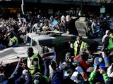 Head coach Pete Carroll of Seattle Seahawks waves to fans during a parade to celebrate their victory in Super Bowl XLVII on February 5, 2014