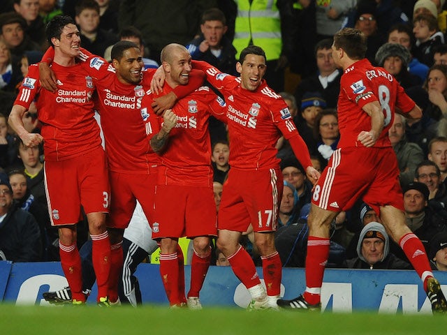 Raul Meireles of Liverpool (C) celebrates with teammates as he scores their first goal during the Barclays Premier League match against Chelsea on February 6, 2011