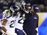 Cornerback Richard Sherman #25 of the Seattle Seahawks is helped off the field during the fourth quarter of Super Bowl XLVIII against the Denver Broncos on February 2, 2014