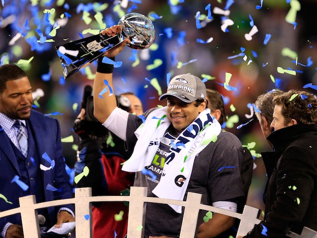 Russell Wilson #3 of the Seattle Seahawks celebrates with the Vince Lombardi trophy after defeating the Denver Broncos 43-8 in Super Bowl XLVIII  on February 2, 2014