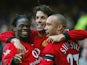 Man United's Ruud Van Nistelrooy celebrates with teammates Luis Saha and Mikael Silvestre after scoring his team's second goal against Everton on February 7, 2004