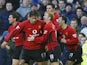 Man United's Ruud Van Nistelrooy celebrates with teammates after scoring his team's fourth goal against Everton during their Premier League match on February 7, 2004