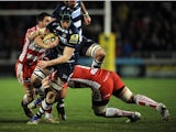 James Gaskell of Sale Sharks is tackled by Sione Kalamafoni of Gloucester during the Aviva Premiership match between Sale Sharks and Gloucester at the AJ Bell Stadium on February 07, 2014