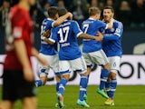 Schalke players celebrate the opening goal against Hannover during their Bundesliga match on February 9, 2014