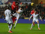 Cardiff striker Kenwyne Jones heads wide during the Barclays Premier League match between Swansea City and Cardiff City at Liberty Stadium on February 8, 2014