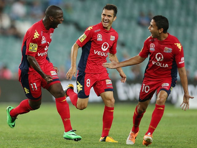 Bruce Djite of Adelaide celebrates scoring a goal with team mates Isaias Sanchez and Marcelo Carrusca during the round 18 A-League match between Sydney FC and Adelaide United at Allianz Stadium on February 8, 2014