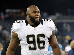 Tom Johnson #96 of the New Orleans Saints walks off the field after a game against the Tennessee Titans on August 30, 2012