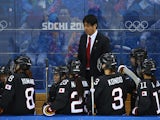 Japanese Head coach Yuji Iizuka speaks to his players during the Women's Ice Hockey Preliminary Round Group B Game between Sweden and Japan on day 2 of the Sochi 2014 Winter Olympics at Shayba Arena on February 9, 2014