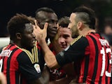 AC Milan's forward Mario Balotelli celebrates with teammate Adil Rami after scoring a goal during the Serie A football match between AC Milan and Bologna at San Siro Stadium in Milan on February 14, 2014