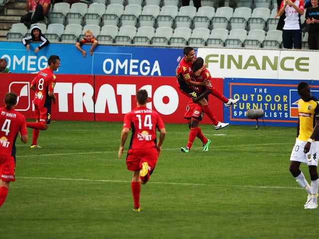 Marcelo Carrusca of United celebrates with his team mate Bruce Djite of United after scoring a goal during the round 19 A-League match between Adelaide United and the Central Coast Mariners at Coopers Stadium on February 14, 2014