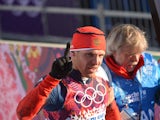 Russia's Anton Gafarov is helped by a volunteer after arriving in the finish area of the Men's Cross-Country Skiing Individual Sprint Free Semifinals at the Laura Cross-Country Ski and Biathlon Center during the Sochi Winter Olympics on February 11, 2014