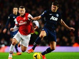 Michael Carrick of Manchester United holds off Jack Wilshere of Arsenal during the Barclays Premier League match between Arsenal and Manchester United at the Emirates Stadium on February 12, 2014