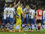 Espanyol´s players celebrate their victory at the end of the Spanish league football match Athletic Bilbao vs Espanyol de Barcelona at the San Mames stadium in Bilbao on February 16, 2014
