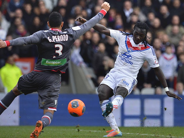 Lyon's Bafetimbi Gomis scores his team's third goal against Ajaccio during their Ligue 1 match on February 16, 2014