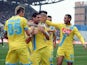 Napoli's Blerim Dzemaili is congratulated by teammates after scoring the opening goal against Sassulo in their Serie A match on February 16, 2014