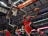 Jimmy Butler #21 of the Chicago Bulls leaps to pass around Andray Blatche #0 of the Brooklyn Nets at the United Center on February 13, 2014