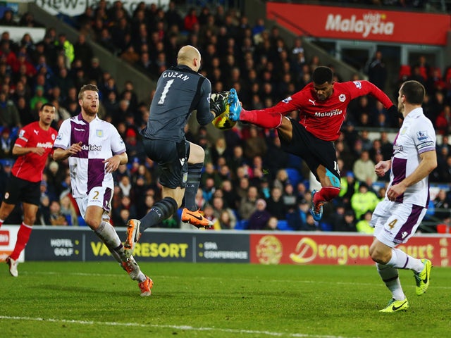 Fraizer Campbell of Cardiff City challenges Bradley Guzan the Aston Villa goalkeeper during the Barclays Premier League match between Cardiff City and Aston Villa at Cardiff City Stadium on February 11, 2014