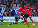 Wigan player Ben Watson challenges Wilfried Zaha of Cardiff during the FA Cup Fifth Round match between Cardiff City and Wigan Athletic at Cardiff City Stadium on February 15, 2014