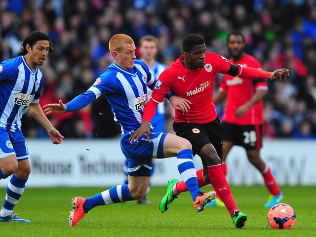 Wigan player Ben Watson challenges Wilfried Zaha of Cardiff during the FA Cup Fifth Round match between Cardiff City and Wigan Athletic at Cardiff City Stadium on February 15, 2014