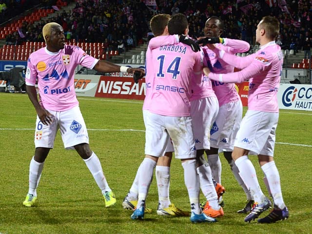 Evian's Cedric Mongongu is congratulated by teammates after scoring his team's second goal against Lille during their Ligue 1 match on February 16, 2014