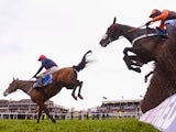 Barry Geraghty on Bob's Worth land safely over the last ahead of Long Run and Sir des Champs on their way to victory in the Chentenham Gold Cup Steeple Chase at Cheltenham Racecourse on March 15, 2013 