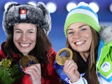Gold medalists Switzerland's Dominique Gisin and Slovenia's Tina Maze pose on the podium during the Women's Alpine Skiing Downhill Medal Ceremony at the Sochi medals plaza during the Sochi Winter Olympics on February 12, 2014