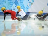 Great Britain's Elise Christie (C) and Italy's Arianna Fontana (R) fall as they compete in the Women's Short Track 500 m Final at the Iceberg Skating Palace during the 2014 Sochi Winter Olympics on February 13, 2014