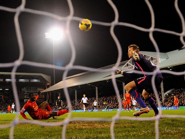 Simon Mignolet of Liverpool looks on as Kolo Toure of Liverpool scores an own goal during the Barclays Premier League match between Fulham and Liverpool at Craven Cottage on February 12, 2014