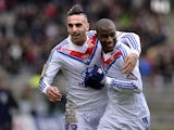 Lyon's Gueida Fofana is congratulated by teammate Miguel Lopes after scoring the opening goal against Ajaccio during their Ligue 1 match on February 16, 2014