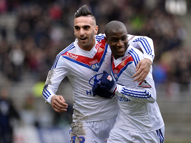 Lyon's Gueida Fofana is congratulated by teammate Miguel Lopes after scoring the opening goal against Ajaccio during their Ligue 1 match on February 16, 2014