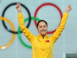 Gold medalist Hong Zhang of China celebrates on the podium during the flower ceremony for the Speed Skating Women's 1000m event on day 6 of Sochi 2014 on February 13, 2014