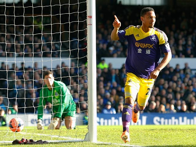 Swansea's Jonathan de Guzman celebrates after scoring his team's opening goal against Everton in their FA Cup fifth round match on February 9, 2014