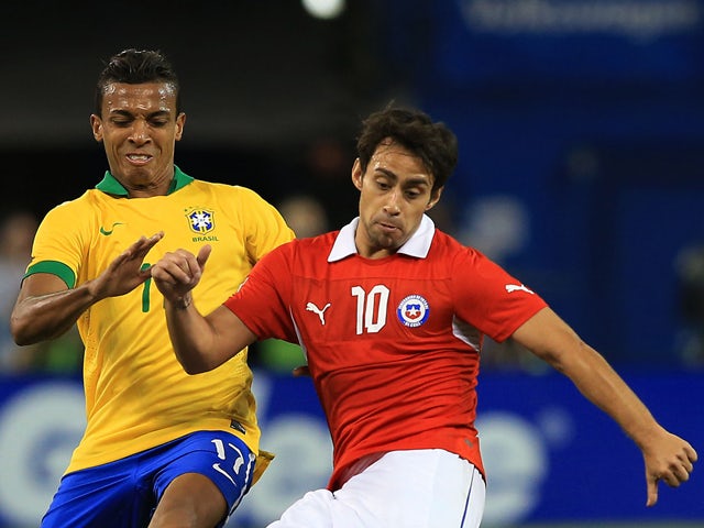 Jorge Valdivia #10 of Chile plays the ball up field as Luiz Gustavo #17 of Brazil defends during a friendly match at Rogers Centre on November 19, 2013
