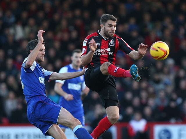 Josh McQuoid of Bournemouth beats Cole Skuse of Ipswich to the ball during the Sky Bet Championship match between AFC Bournemouh and Ipswich Town at The Goldsands Stadium on December 29, 2013