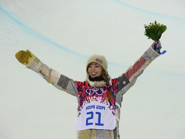 Gold Medallist,US Kaitlyn Farrington celebrates at the Women's Snowboard Halfpipe Flower Ceremony at the Rosa Khutor Extreme Park during the Sochi Winter Olympics on February 12, 2014