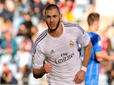 Real's Karim Benzema celebrates after scoring his team's second goal against Getafe during their La Liga match on February 16, 2014